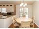 An eat-in kitchen area featuring a round wooden table, four chairs, french doors, and recessed lighting at 1468 Cheyenne Ct, Stone Mountain, GA 30087