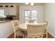Cozy eat-in kitchen nook with a round wooden table, chairs, and french doors for natural lighting at 1468 Cheyenne Ct, Stone Mountain, GA 30087