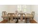 Elegant dining room featuring a wooden table with six chairs and natural light from the window at 1468 Cheyenne Ct, Stone Mountain, GA 30087