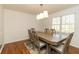 Dining room with hardwood floors, ample natural light, and a classic dining set for six at 1468 Cheyenne Ct, Stone Mountain, GA 30087