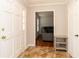 Foyer featuring a white door, tile flooring, coat closet, and a view into the hardwood-floored living room at 1468 Cheyenne Ct, Stone Mountain, GA 30087