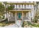 Charming two-story home with a welcoming front porch, blue door, and well-maintained landscaping at 1468 Cheyenne Ct, Stone Mountain, GA 30087