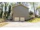 Spacious two-car garage featuring painted doors and an extended driveway for ample parking at 1468 Cheyenne Ct, Stone Mountain, GA 30087
