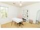Bright and airy home office with a stylish desk, ample storage, and natural light from a large window at 1468 Cheyenne Ct, Stone Mountain, GA 30087