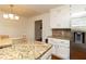Spacious kitchen with granite countertops, stainless steel refrigerator and adjacent breakfast area at 1468 Cheyenne Ct, Stone Mountain, GA 30087