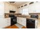 Well-equipped kitchen featuring a stove, dishwasher and white cabinetry at 1468 Cheyenne Ct, Stone Mountain, GA 30087