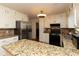 Stylish kitchen with granite counters, stainless steel appliances and bright lighting at 1468 Cheyenne Ct, Stone Mountain, GA 30087