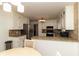 Cozy kitchen featuring white cabinets, granite countertops and stainless steel appliances at 1468 Cheyenne Ct, Stone Mountain, GA 30087