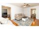 Inviting living room with hardwood floors, a ceiling fan, and a seamless flow to the dining area at 1468 Cheyenne Ct, Stone Mountain, GA 30087