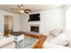 Bright living room with hardwood floors, a brick fireplace, and a view into the dining area at 1468 Cheyenne Ct, Stone Mountain, GA 30087