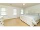 Spacious main bedroom with neutral walls, plush carpet, and a large bed with decorative headboard at 1468 Cheyenne Ct, Stone Mountain, GA 30087