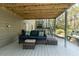 A covered patio with a wicker sofa set offers comfortable backyard relaxation space at 1468 Cheyenne Ct, Stone Mountain, GA 30087