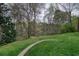 Beautiful backyard with mature trees sloping down to a lake at 1510 Wood Thrush Way, Marietta, GA 30062