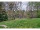 Expansive grassy backyard with mature trees and lake views at 1510 Wood Thrush Way, Marietta, GA 30062