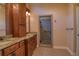 Bathroom with double vanity, granite countertops, dark wood cabinets, and glass enclosed shower at 1510 Wood Thrush Way, Marietta, GA 30062