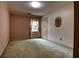 Bedroom with neutral walls, carpet, and a window covered with lace curtains at 1510 Wood Thrush Way, Marietta, GA 30062
