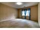 Bedroom featuring patterned wallpaper and large window with blue valance at 1510 Wood Thrush Way, Marietta, GA 30062