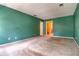 Spacious bedroom with green walls, neutral carpet, and a doorway leading to another room at 1510 Wood Thrush Way, Marietta, GA 30062
