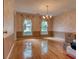 Formal dining room with hardwood floors, chandelier, decorative wallpaper and ample natural light from large windows at 1510 Wood Thrush Way, Marietta, GA 30062