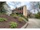 Side view of home with a brick front, light yellow siding, and driveway leading to a detached two-car garage at 1510 Wood Thrush Way, Marietta, GA 30062
