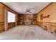 Spacious carpeted living room featuring a brick fireplace flanked by built-in shelving units and a large picture window at 1510 Wood Thrush Way, Marietta, GA 30062