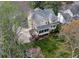 Beautiful home's rear exterior with a screened porch and large grassy yard at 1510 Wood Thrush Way, Marietta, GA 30062