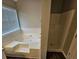 Inviting bathroom with soaking tub, and glass-enclosed shower at 3763 Waldrop Hills Dr, Decatur, GA 30034