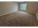 Spacious carpeted bedroom with large window providing natural light at 3763 Waldrop Hills Dr, Decatur, GA 30034
