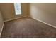 Cozy bedroom with neutral walls and plush carpeting, lit by a bright window at 3763 Waldrop Hills Dr, Decatur, GA 30034