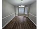 Unfurnished dining room featuring new wood flooring, chair-rail molding, and modern lighting at 3763 Waldrop Hills Dr, Decatur, GA 30034