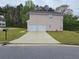 View of the rear of the house with a two-car garage and long driveway at 3763 Waldrop Hills Dr, Decatur, GA 30034