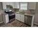 Kitchen with stainless steel appliances, granite counters, and white cabinetry, ready for cooking at 3763 Waldrop Hills Dr, Decatur, GA 30034
