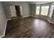 Empty living room with new wood flooring and large windows, offering a bright, welcoming space at 3763 Waldrop Hills Dr, Decatur, GA 30034