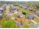 Aerial view of a charming neighborhood featuring well-manicured lawns, mature trees, and beautifully maintained homes at 4560 Evandale Way, Cumming, GA 30040