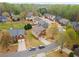 Aerial view of a residential neighborhood showcasing well-maintained homes, mature trees, and inviting landscaping at 4560 Evandale Way, Cumming, GA 30040