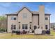Spacious backyard with patio, lawn, mature trees providing a serene outdoor setting perfect for relaxation and entertaining at 4560 Evandale Way, Cumming, GA 30040