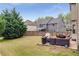Spacious backyard with a patio area, complete with outdoor furniture and well-maintained lawn, great for entertaining at 4560 Evandale Way, Cumming, GA 30040