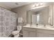 Bright bathroom offers double sinks, tile floors, and a decorative shower curtain at 4560 Evandale Way, Cumming, GA 30040