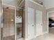 Modern bathroom boasts a glass-enclosed shower with neutral tile and double doors at 4560 Evandale Way, Cumming, GA 30040