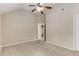 Spacious bedroom boasts carpeted floors, a ceiling fan, and a view to the en-suite bath at 4560 Evandale Way, Cumming, GA 30040