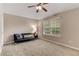 Bedroom showcases carpeted floors, a ceiling fan, and a comfortable seating area at 4560 Evandale Way, Cumming, GA 30040