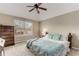 Cozy bedroom featuring a large window and a comfortable bed with patterned bedding at 4560 Evandale Way, Cumming, GA 30040