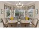 Cozy breakfast nook with banquette seating, pendant lighting, and decorative window treatments at 4560 Evandale Way, Cumming, GA 30040