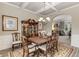Formal dining room featuring coffered ceilings, wood furniture, and elegant chandelier at 4560 Evandale Way, Cumming, GA 30040