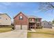 Charming two-story brick home with a well-manicured lawn and attached two-car garage, providing curb appeal at 4560 Evandale Way, Cumming, GA 30040