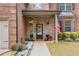 Charming brick home featuring a stone entryway and a beautifully decorated front door with seasonal accents and inviting curb appeal at 4560 Evandale Way, Cumming, GA 30040