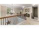 Upstairs hallway with natural light, decorative railing and views to a bedroom at 4560 Evandale Way, Cumming, GA 30040