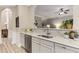 Wet bar with stainless dishwasher, granite countertops, tile backsplash, and neutral cabinets at 4560 Evandale Way, Cumming, GA 30040