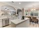 Bright kitchen with stainless steel appliances, an island with breakfast bar, and a cozy breakfast nook with ample natural light at 4560 Evandale Way, Cumming, GA 30040