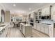 Well-lit kitchen with white cabinets, stainless steel appliances, a center island, a built-in breakfast nook, and modern finishes at 4560 Evandale Way, Cumming, GA 30040